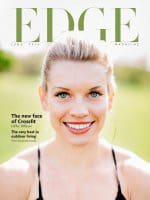 Close-up of a smiling woman on the cover of EDGE magazine, with text highlighting 