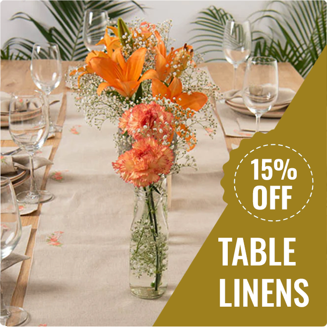 Fashion Cleaners A dining table set with glassware, plates, and orange floral centerpieces; a gold banner displays "15% OFF TABLE LINENS.