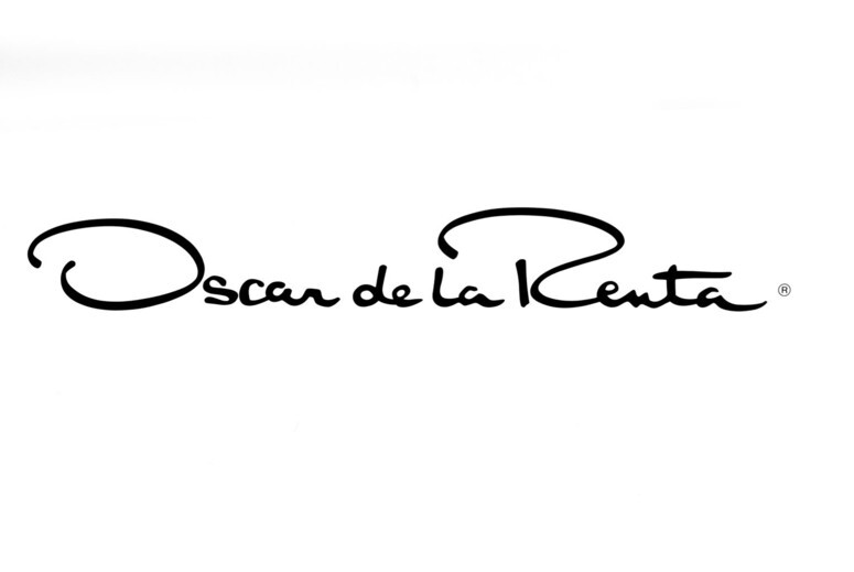 Fashion Cleaners The Oscar de la Renta logo is displayed in elegant, black cursive text on a white background.